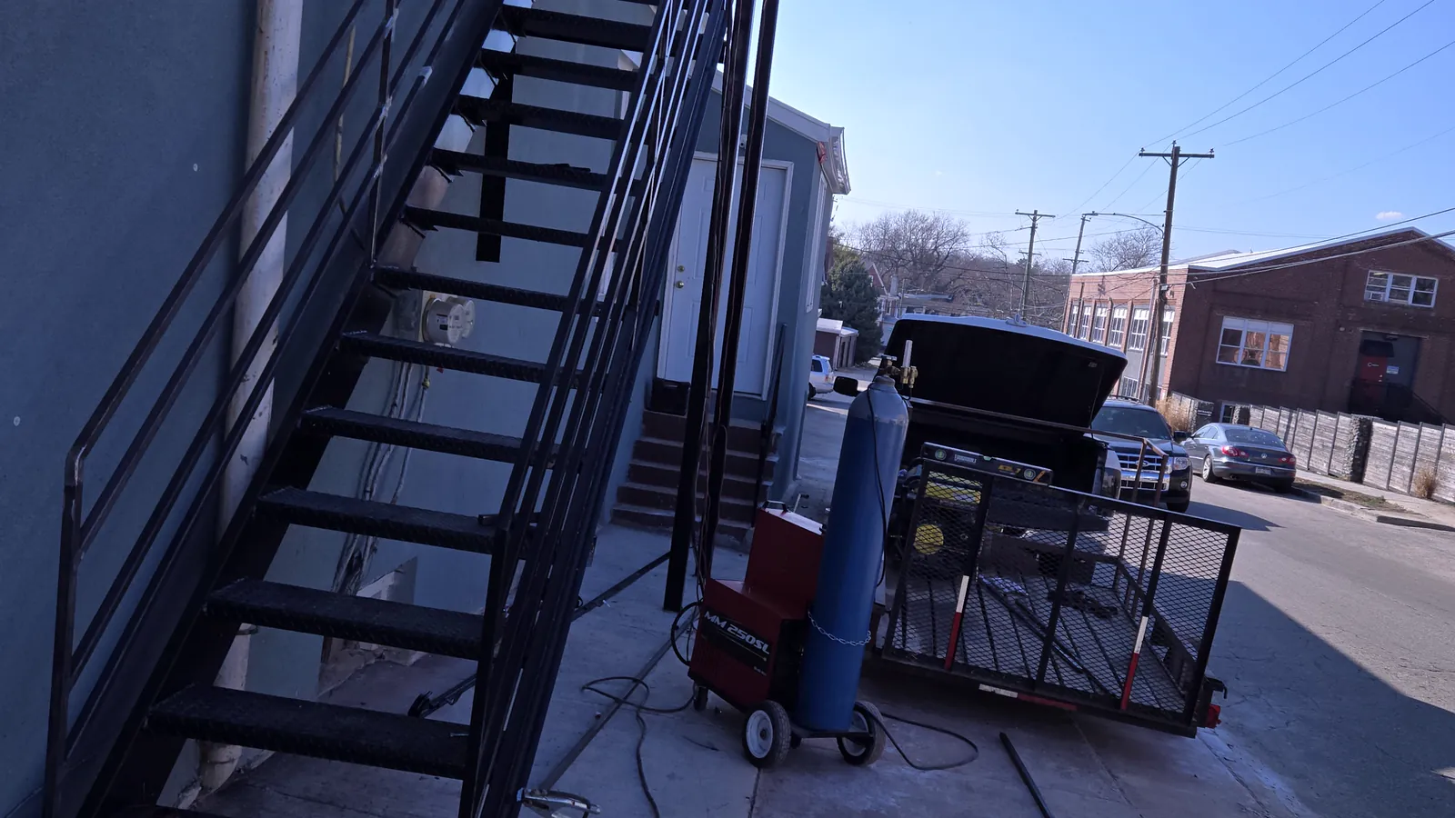 Exterior steel stairs built by Reyesruiz Welding, with the welding rig beside them