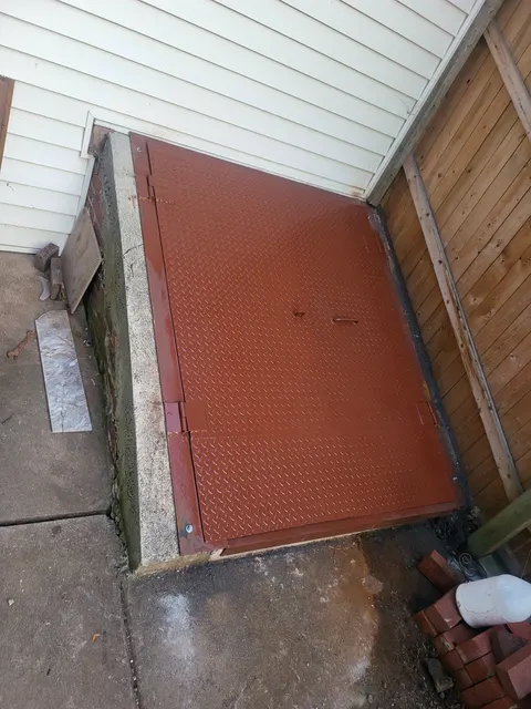 Flat diamond-plate basement door